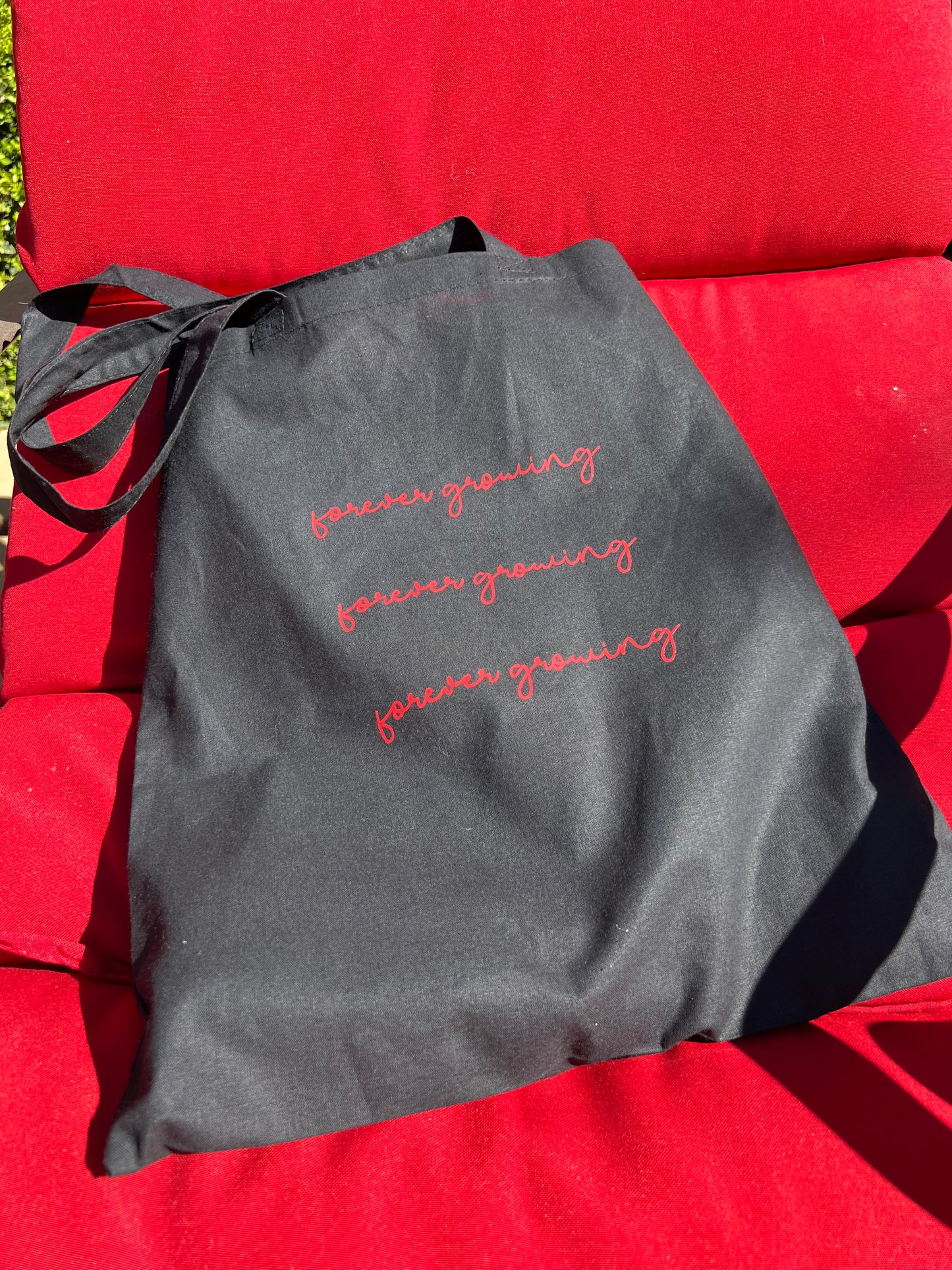 black tote bag red text on red pool chair