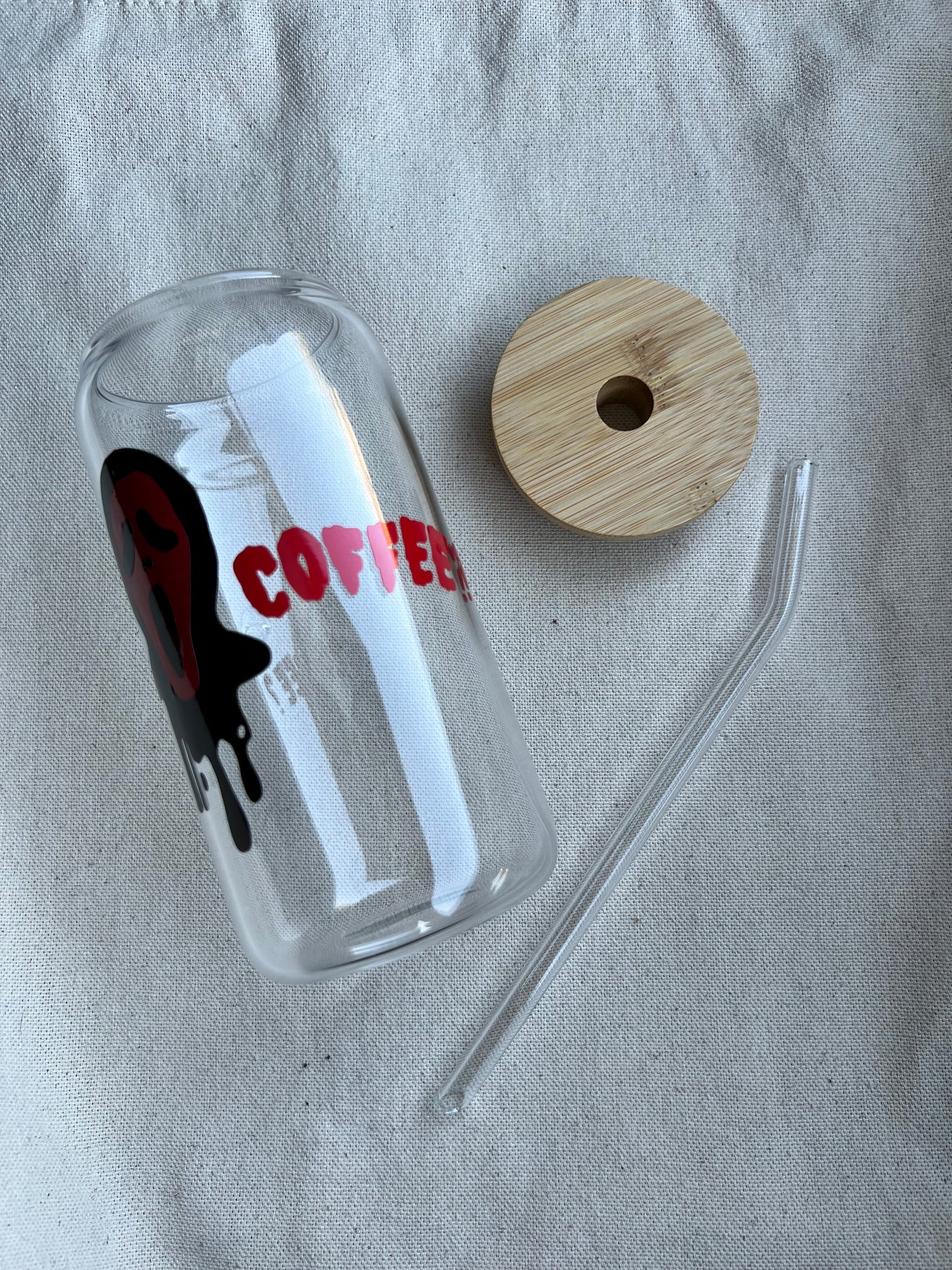 20 oz glass can with red text and a bamboo lid and glass straw