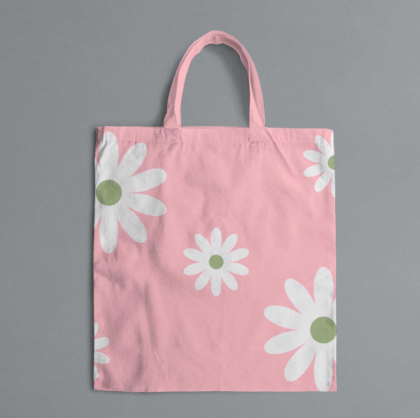 light pink tote bag with white flowers on gray background